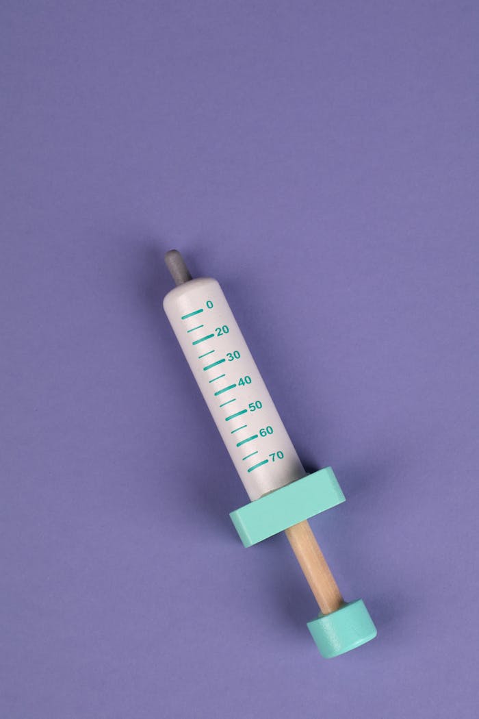 Crafting Captivating Headlines: Your awesome post title goes here Close-up of a colorful toy syringe on a purple background, ideal for educational and healthcare concepts.